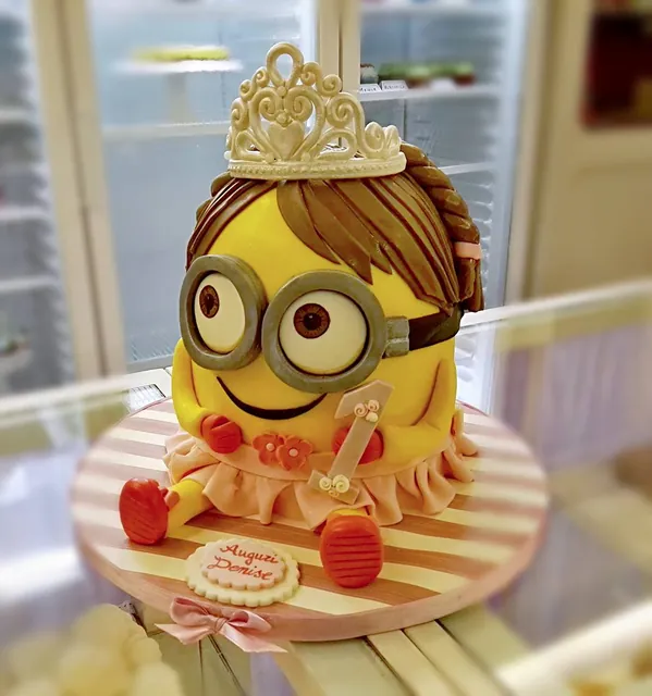 Il Minion principessa con tiara e fiocchi rossi